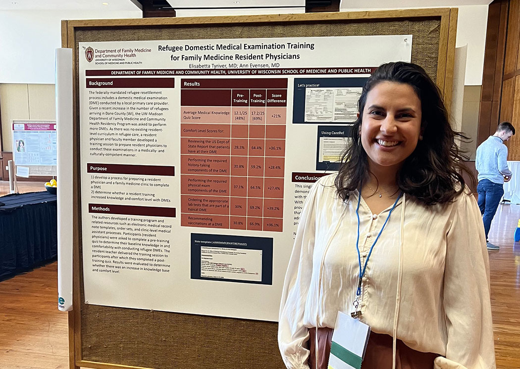 Elisabetta Tyriver, MD with poster related to refugee clinic work.