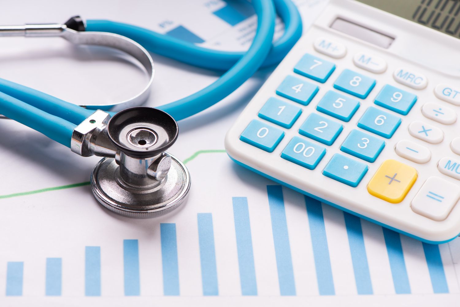 A calculator, stethoscope, and paper graph.