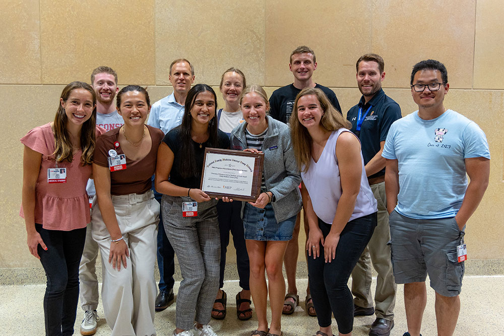 FMIG students pose with 2024 Program of Excellence certificate.