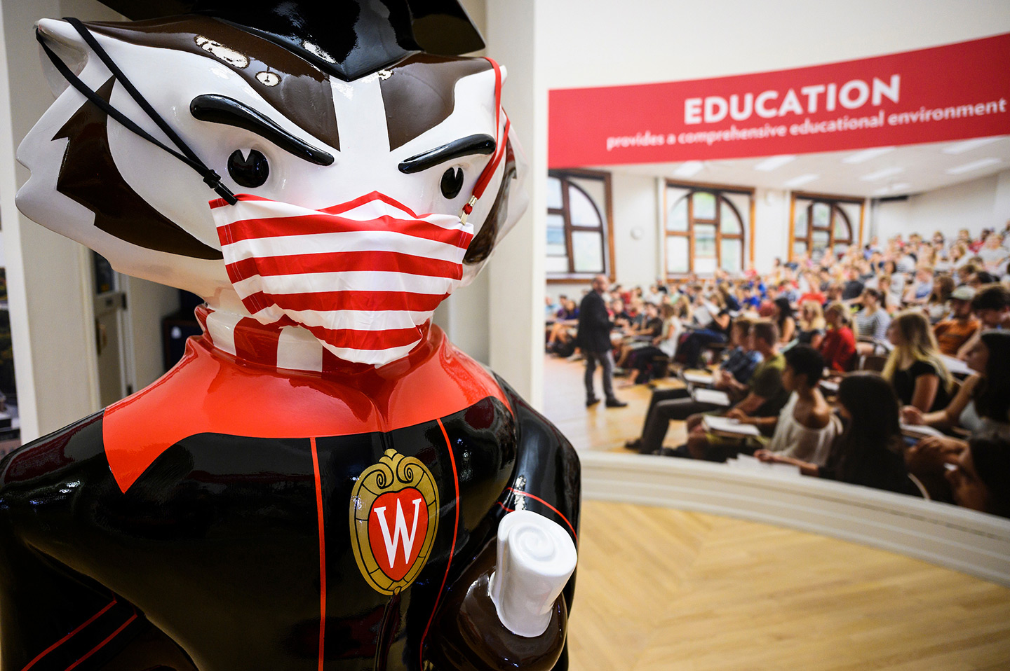 The Graduation Bucky statue is pictured wearing a face mask in the rotunda of Bascom Hall at the University of Wisconsin-Madison on Nov. 21, 2020. The replica of UW-Madison mascot Bucky Badger was practicing physical distancing as the global coronavirus (COVID-19) pandemic continues. (Photo by Jeff Miller / UW-Madison)