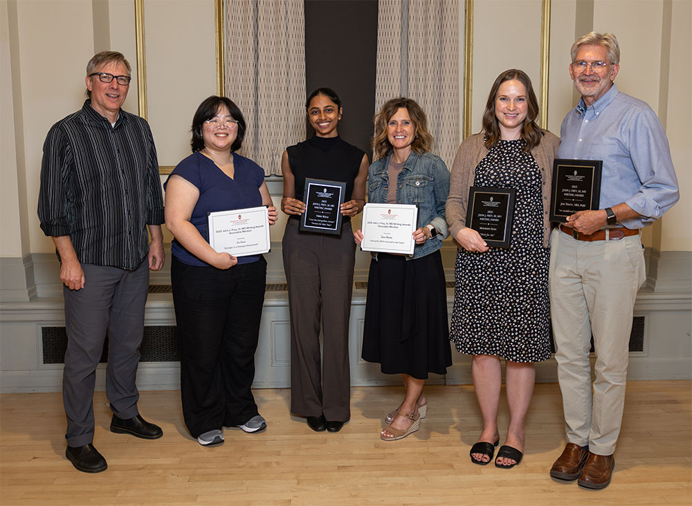 Group photo of six people with winners holding awards.