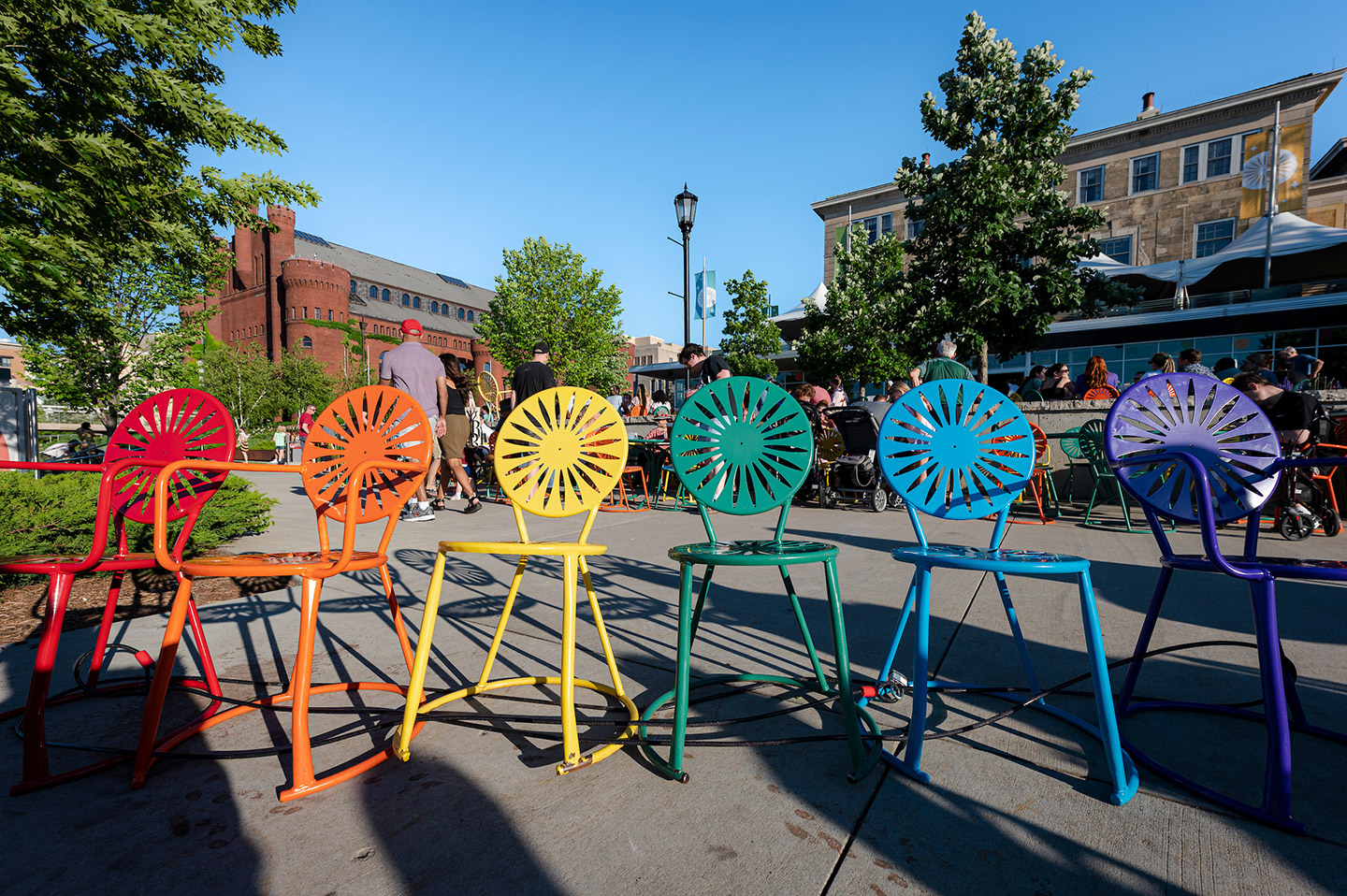 Union chairs at Memorial Union painted in the colors of the Pride flag.