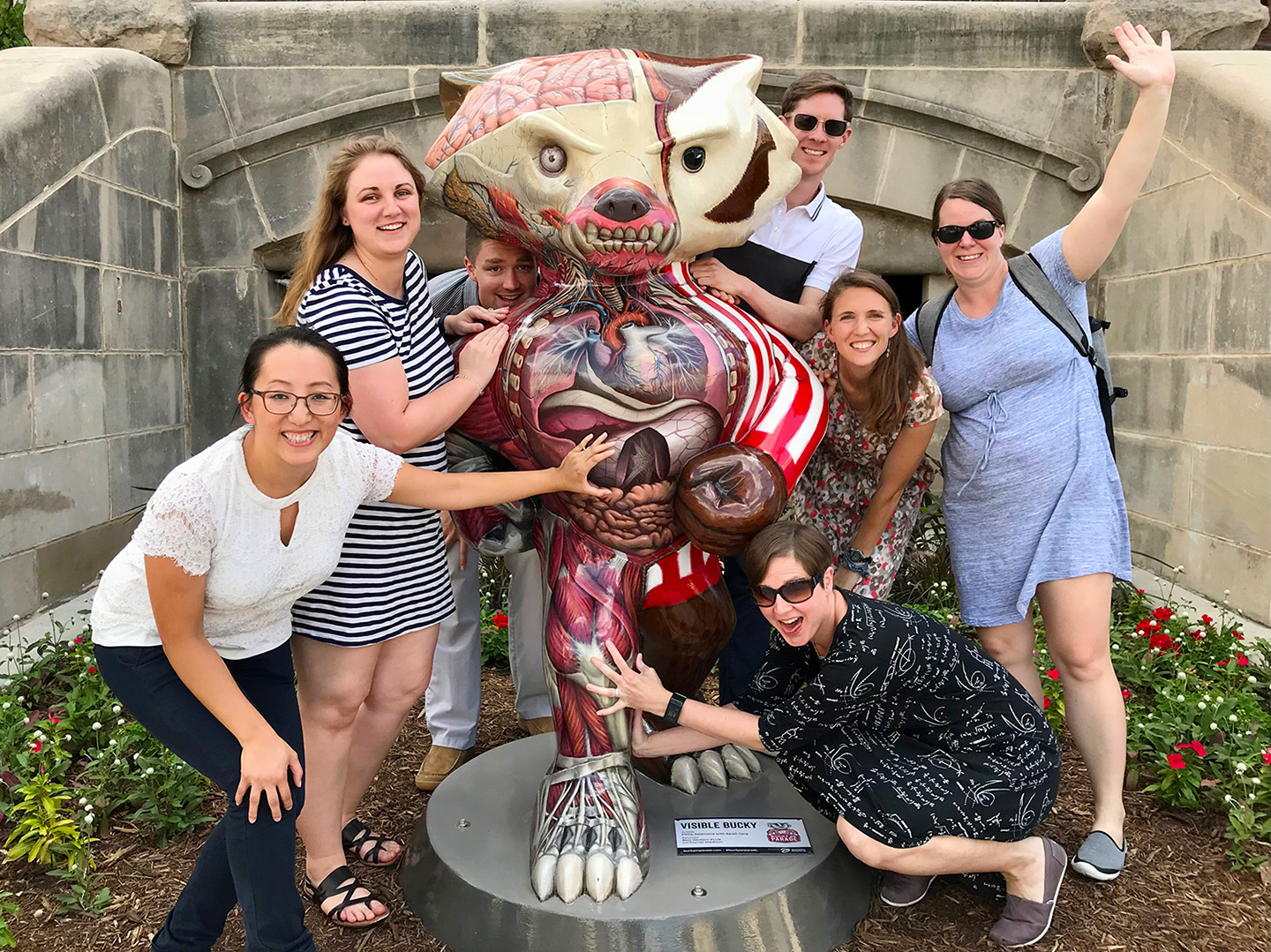 A group from the UW Family Medicine Madison Residency program poses with a Bucky Badger statue that is painted to show his insides.