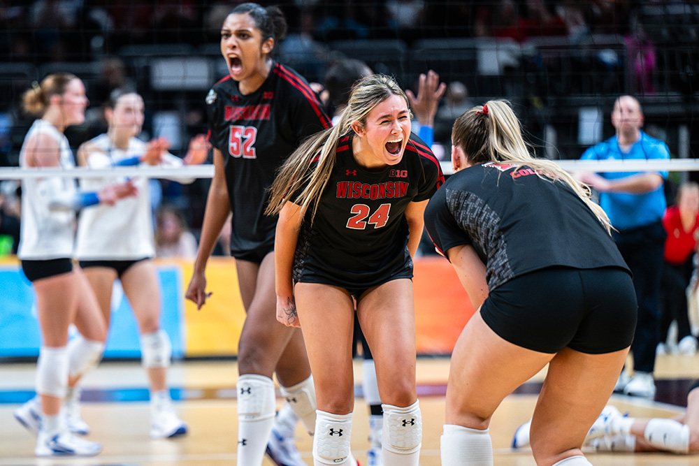 UW Women's Volleyball players celebrate after a point.