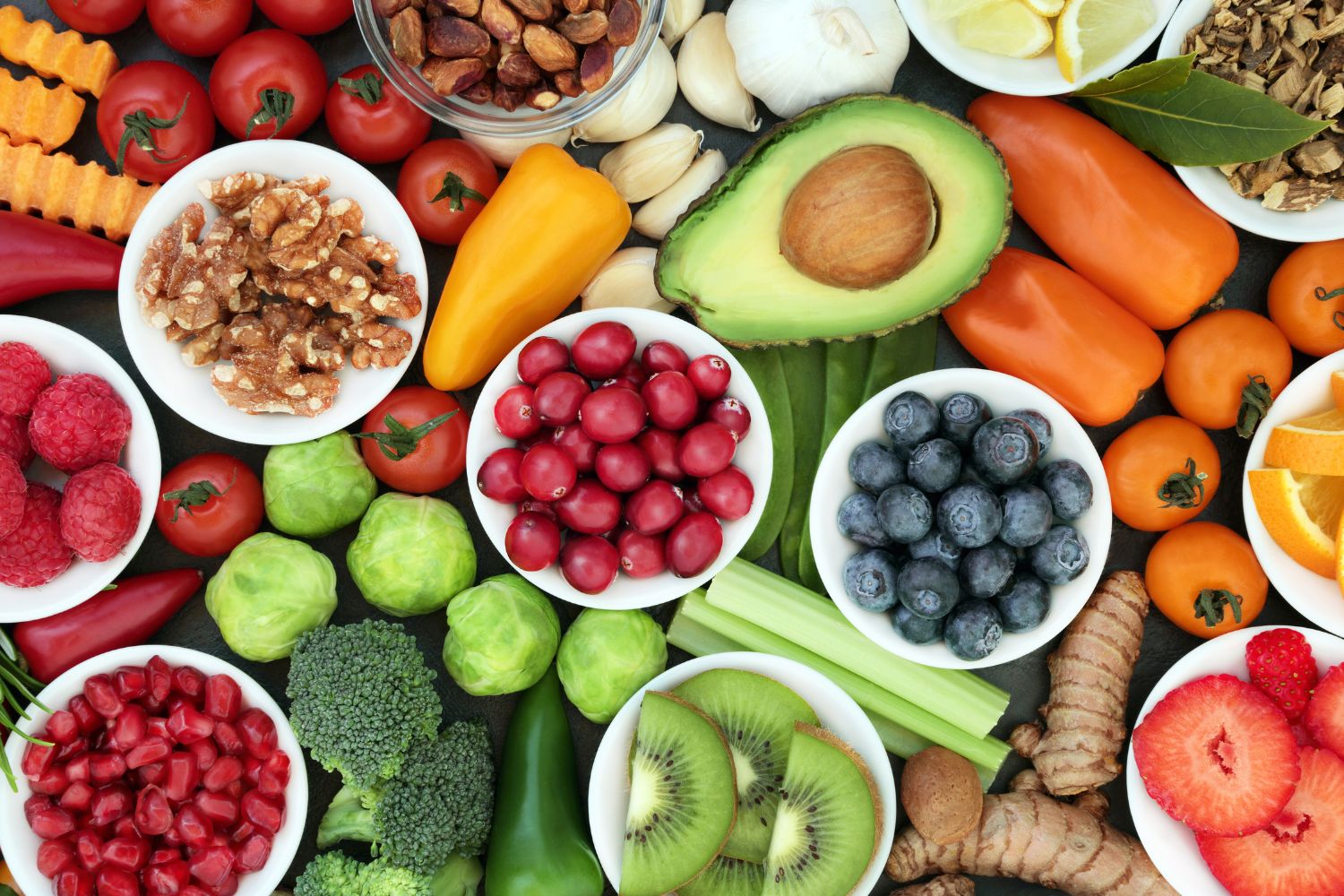 Close up of healthy super foods showing fruit, vegetables, and nuts.
