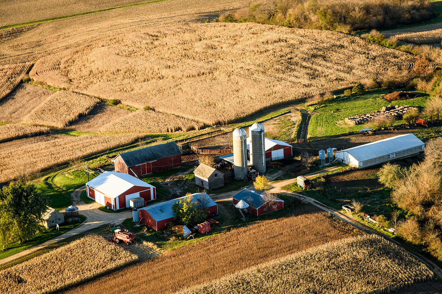 Ariel view of a Wisconsin farm, showing cluster of building in middle of field in fall.