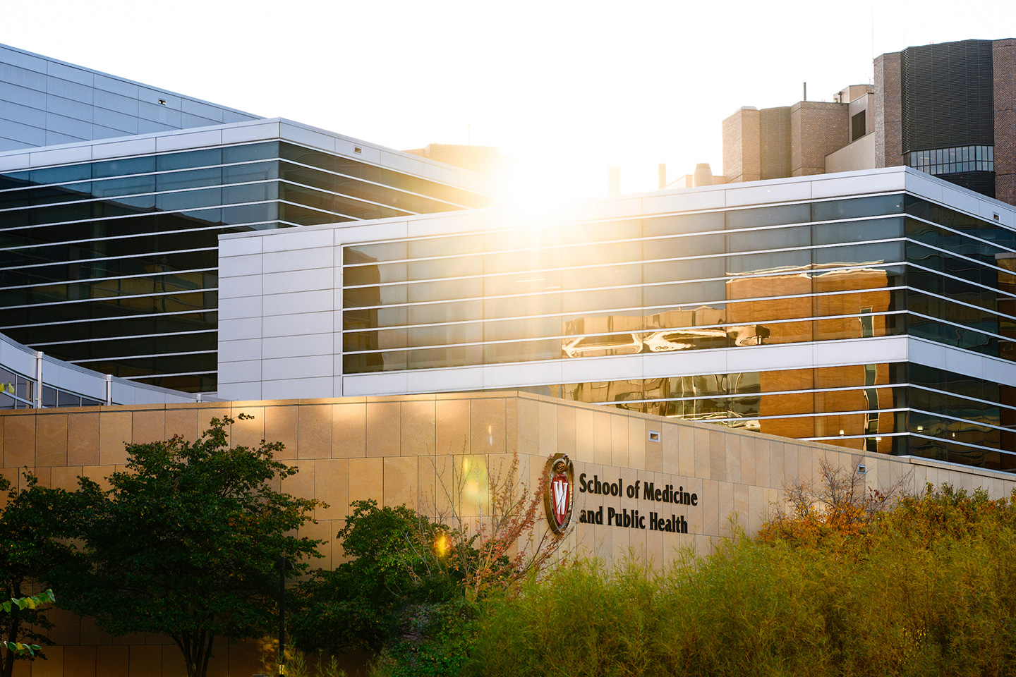 The sun flares above the Health Sciences Learning Center (HSLC), home to the School of Medicine and Public Health, on an autumn day at the University of Wisconsin–Madison.