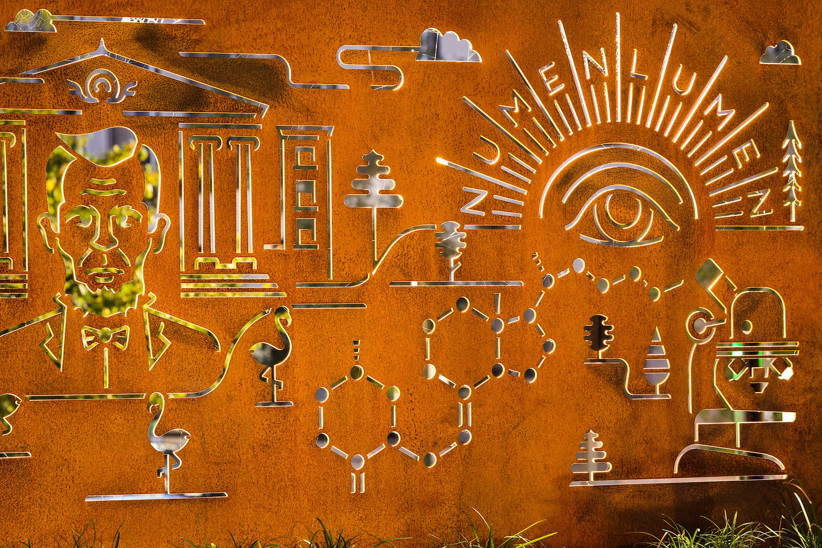 Cut into rusted-steel, backlit and iconic graphics of the Badger Pride Wall – including Bascom Hall, Abraham Lincoln, the Numen Lumen seal and Vitamin D research – are part of the many informational displays featured at Alumni Park at the University of Wisconsin-Madison.