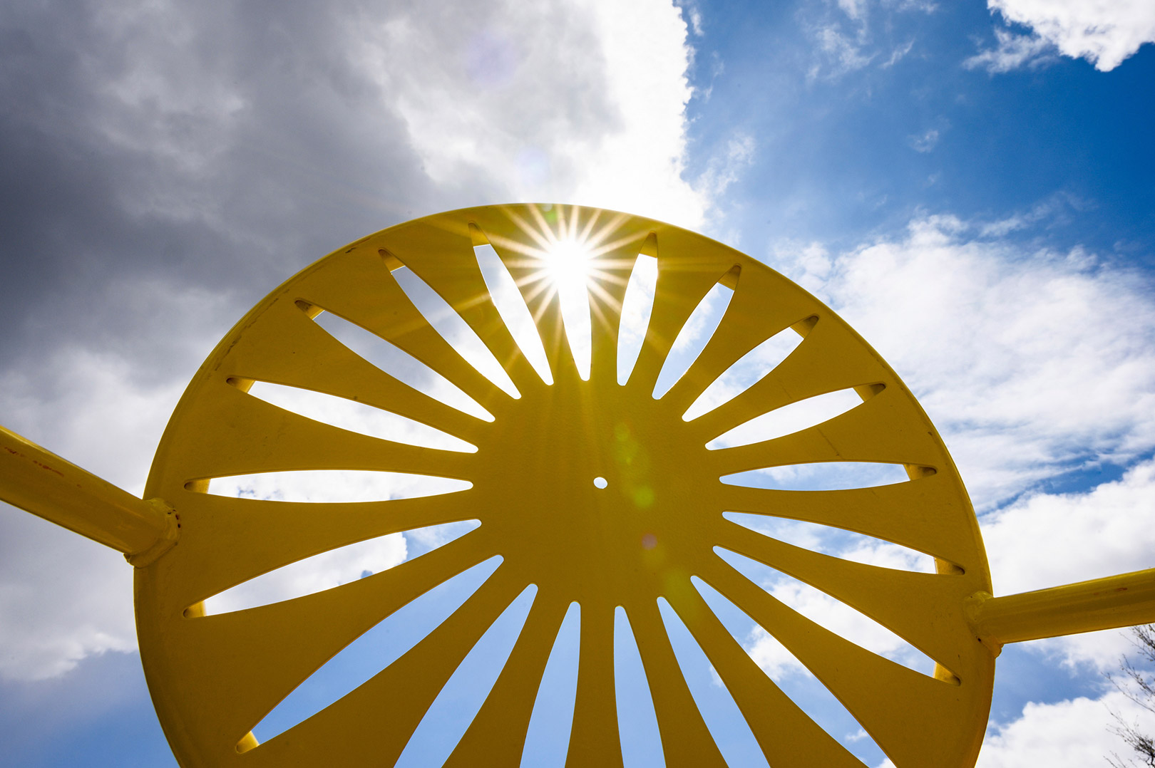 Memorial union terrace chair with backlit sun rays.