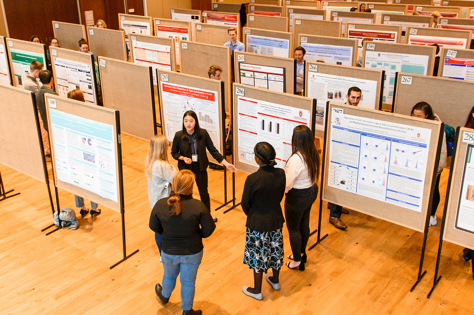 UW students share their poster projects with visitors during the Undergraduate Symposium in Varsity Hall inside of Union South at the University of Wisconsin-Madison.