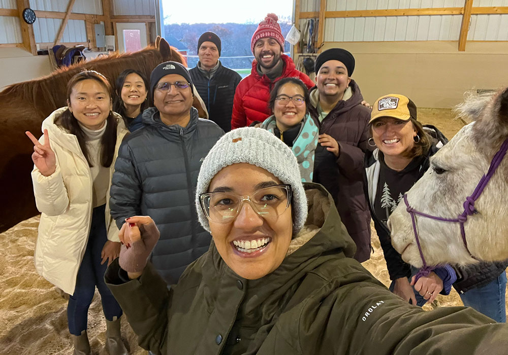 Integrative health fellows group with farm animals.