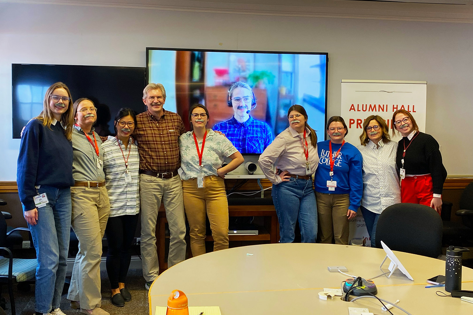 Humorous group photo of Temte Team all wearing fake mustaches to mimic Dr. Temte's trademark mustache.