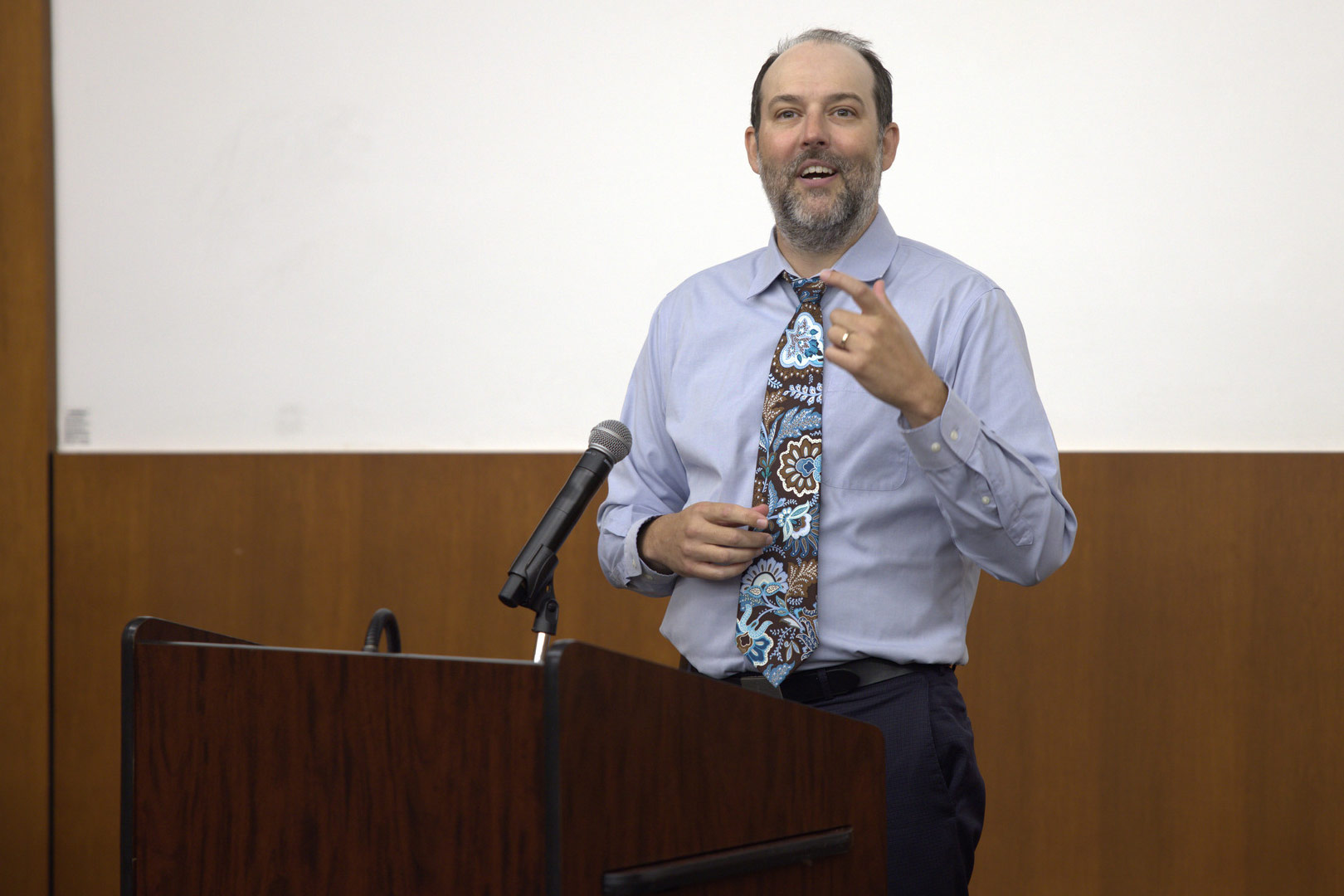 James Bigham, MD, MPH, presents from behind a podium.