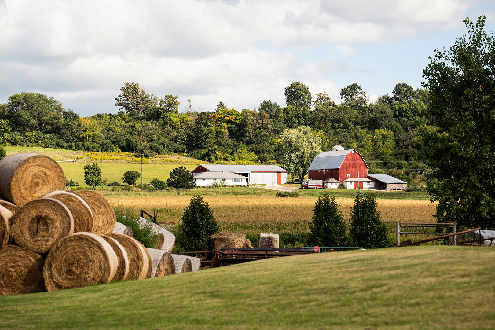 Rural farmland with a red barn is pictured in Calumet County, Wisconsin during a late summer day.