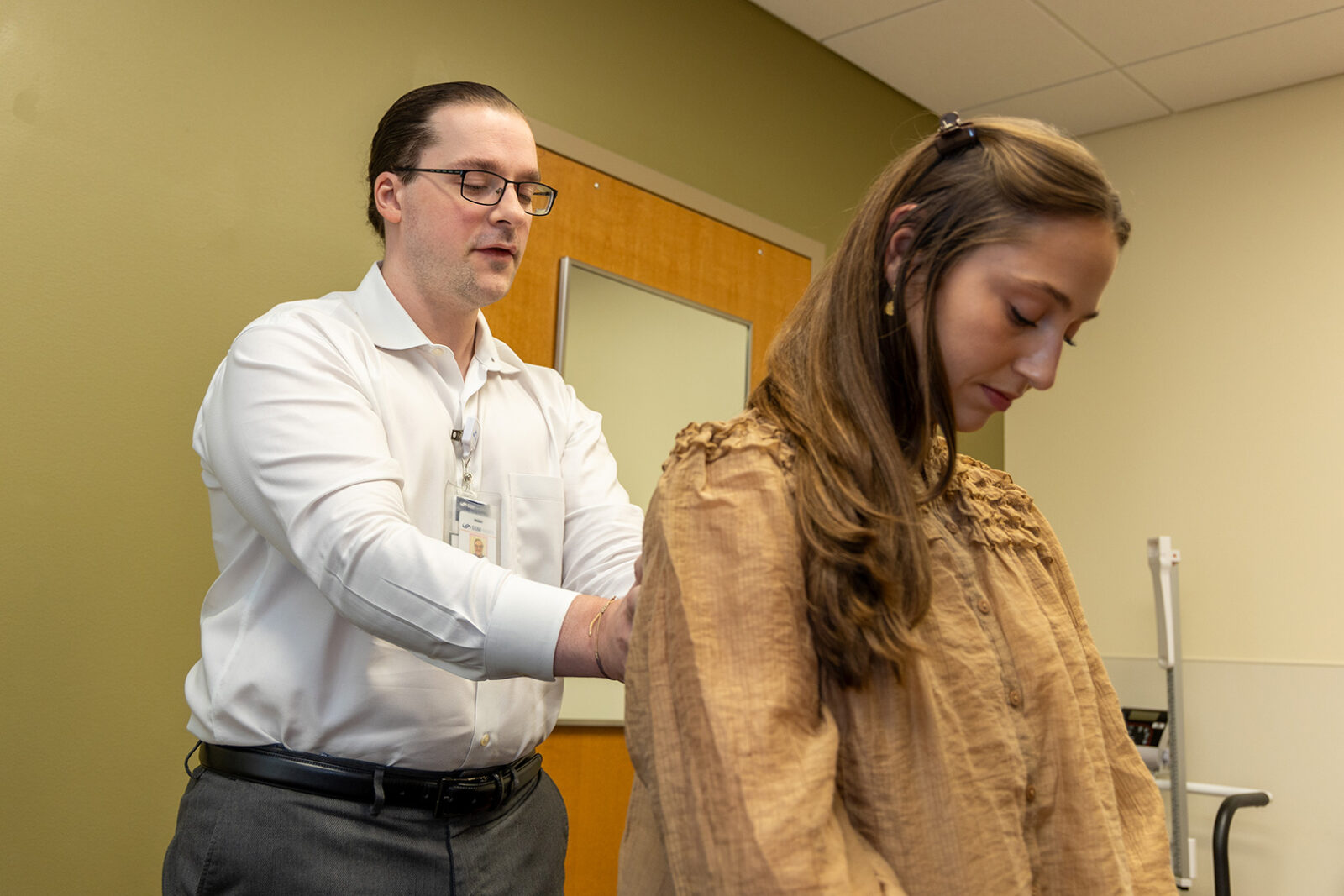 Doctor examining and patients back in a clinic.